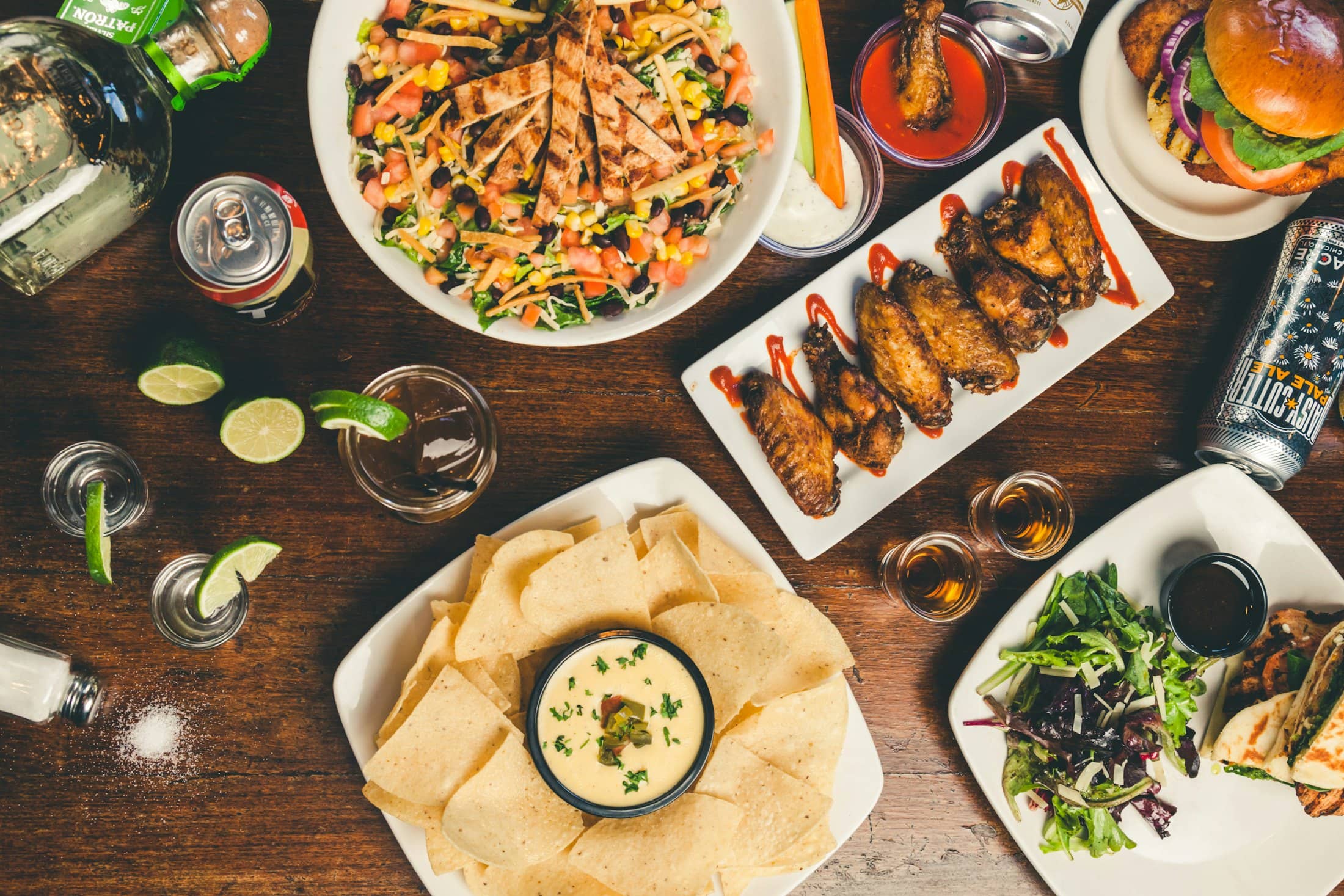 A table spread with several plates of food and sides